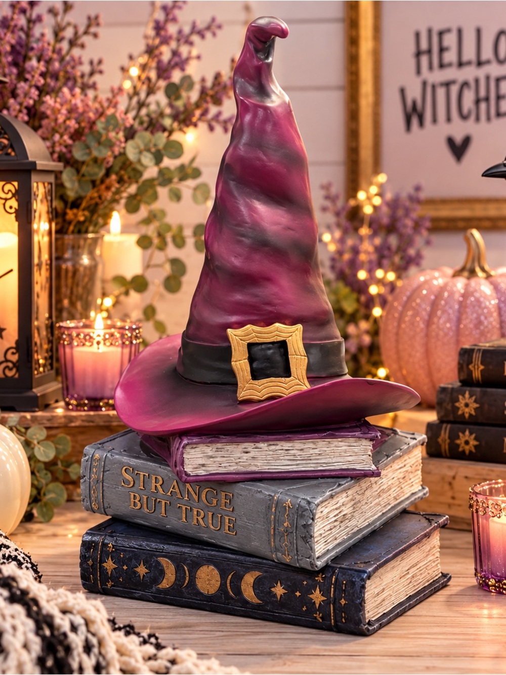 NWT Enchanting resin purple witch hat with a gold buckle over a spooky book stac